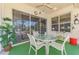 A screened-in patio with a table, a ceiling fan, outdoor seating, and scenic views at 14270 Reserve Ct, Port Charlotte, FL 33953