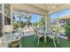 A screened patio with a seating area, a table, and views of the landscaped backyard and pool at 14270 Reserve Ct, Port Charlotte, FL 33953
