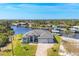 Breathtaking aerial view of a waterfront home with lush greenery and boat docks, a serene retreat at 14286 Fort Worth Cir, Port Charlotte, FL 33981