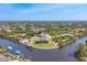 Scenic aerial view highlighting a waterfront home with a boat dock in a charming neighborhood setting at 14286 Fort Worth Cir, Port Charlotte, FL 33981