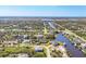 Wide aerial view of a residential area featuring waterfront homes situated along winding canals and waterways at 14286 Fort Worth Cir, Port Charlotte, FL 33981