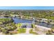 Expansive aerial view of a waterfront property featuring lush landscaping and a serene canal setting at 14286 Fort Worth Cir, Port Charlotte, FL 33981