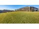 Expansive backyard with manicured lawn, lush green grass leading up to waterfront home with screened lanai at 14286 Fort Worth Cir, Port Charlotte, FL 33981