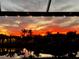 Stunning waterfront sunset view from the backyard, reflecting over the peaceful water feature at 14286 Fort Worth Cir, Port Charlotte, FL 33981