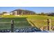 Waterfront backyard featuring a well-maintained lawn, screened-in lanai, and stone accents along the water's edge at 14286 Fort Worth Cir, Port Charlotte, FL 33981