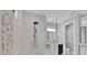Modern bathroom showcases decorative tiles in the glass shower and offers a peek at the vanity with sink at 14286 Fort Worth Cir, Port Charlotte, FL 33981