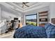This primary bedroom offers views of the outdoors, a ceiling fan, and stylish, modern decor at 14286 Fort Worth Cir, Port Charlotte, FL 33981