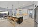 Bright kitchen featuring a large island with seating, white cabinets, and stainless steel appliances, perfect for entertaining at 14286 Fort Worth Cir, Port Charlotte, FL 33981