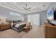 Calm bedroom featuring a tray ceiling, neutral tones, large bed, soft lighting, and ample natural light at 14286 Fort Worth Cir, Port Charlotte, FL 33981