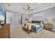 Spacious main bedroom featuring a tray ceiling, neutral tones, large bed, soft lighting, and ample natural light at 14286 Fort Worth Cir, Port Charlotte, FL 33981