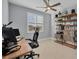 This home office space has great natural light, a ceiling fan, and sleek modern decor at 14286 Fort Worth Cir, Port Charlotte, FL 33981