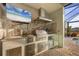 Well equipped outdoor kitchen featuring stainless steel grill and countertops under a covered patio at 14286 Fort Worth Cir, Port Charlotte, FL 33981
