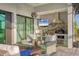 Inviting outdoor kitchen and sitting area featuring modern appliances and comfortable seating at 14286 Fort Worth Cir, Port Charlotte, FL 33981