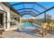 Spacious pool area with lounge chairs and outdoor kitchen access, perfect for entertaining at 14286 Fort Worth Cir, Port Charlotte, FL 33981