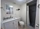 Bathroom featuring modern vanity, decorative mirror and walk-in shower at 150 Englewood Isles Pkwy # 201, Englewood, FL 34223