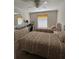 Bedroom with two twin beds, a dresser, and a ceiling fan at 150 Englewood Isles Pkwy # 201, Englewood, FL 34223