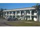 Multi-Gathering home with a tile roof, arches, staircases, and a silver truck in the driveway at 150 Englewood Isles Pkwy # 201, Englewood, FL 34223