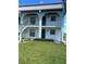 Two story condo building with a lush green lawn and lovely archways on the upper level at 150 Englewood Isles Pkwy # 201, Englewood, FL 34223