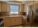 Bright kitchen featuring white cabinets, stainless steel appliances, and a double basin sink at 150 Englewood Isles Pkwy # 201, Englewood, FL 34223