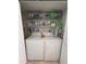 Convenient laundry area features a full-size washer and dryer, along with built-in shelving for ample storage at 150 Englewood Isles Pkwy # 201, Englewood, FL 34223