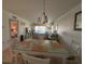 Open-concept space with a dining area and a living room featuring water views at 150 Englewood Isles Pkwy # 201, Englewood, FL 34223