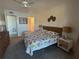 Bedroom featuring a ceiling fan, and a bed with a colorful floral pattern at 150 Englewood Isles Pkwy # 201, Englewood, FL 34223