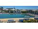 Community swimming pool with lounge chairs and mature landscaping and people enjoying the water at 150 Englewood Isles Pkwy # 201, Englewood, FL 34223