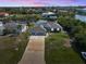 Aerial view of home, manicured lawns, and a private dock on the canal at 15251 Appleton Blvd, Port Charlotte, FL 33981