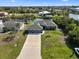 Aerial view of home, manicured lawns, and a private dock on the canal at 15251 Appleton Blvd, Port Charlotte, FL 33981