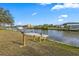 Lush lawn leading to a private wooden dock along a scenic canal at 15251 Appleton Blvd, Port Charlotte, FL 33981