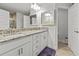 Bright bathroom featuring double sinks, granite counters, and sleek white cabinetry at 15251 Appleton Blvd, Port Charlotte, FL 33981