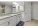 Bright bathroom featuring double sinks, granite counters, and sleek white cabinetry at 15251 Appleton Blvd, Port Charlotte, FL 33981