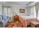Cozy bedroom featuring a comfortable bed and sitting area by the window at 15251 Appleton Blvd, Port Charlotte, FL 33981