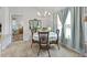 Bright dining area with stylish chandelier, round table, and comfortable chairs at 15251 Appleton Blvd, Port Charlotte, FL 33981