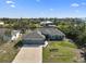 Charming single-story home featuring a three-car garage and well-manicured lawn with beautiful landscaping at 15251 Appleton Blvd, Port Charlotte, FL 33981