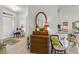 Inviting entryway with a charming dresser and mirror, adjacent to the open-concept kitchen and living areas at 15251 Appleton Blvd, Port Charlotte, FL 33981