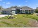 Charming single-story home featuring a well-manicured lawn and a two-car garage at 15251 Appleton Blvd, Port Charlotte, FL 33981