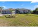 Well maintained home with a three car garage, an inviting entrance and a verdant, manicured front yard at 15251 Appleton Blvd, Port Charlotte, FL 33981