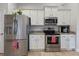 Kitchen featuring stainless steel appliances, white cabinets and granite countertops at 15251 Appleton Blvd, Port Charlotte, FL 33981