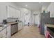 Bright kitchen with stainless steel appliances, granite countertops and white cabinetry at 15251 Appleton Blvd, Port Charlotte, FL 33981