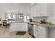 Kitchen featuring stainless steel appliances, white cabinets and granite countertops at 15251 Appleton Blvd, Port Charlotte, FL 33981