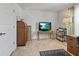 Well-lit office with wood furnishings, decorative rug, and large flatscreen television at 15251 Appleton Blvd, Port Charlotte, FL 33981