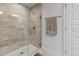 Modern walk-in shower with neutral tiling and glass door at 15251 Appleton Blvd, Port Charlotte, FL 33981