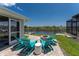 Beautiful backyard with lounge chairs overlooking a serene waterfront and private dock at 15738 Applewhite Cir, Port Charlotte, FL 33981
