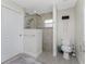 Bathroom with walk-in shower featuring glass enclosure, pebble flooring, and modern fixtures at 15738 Applewhite Cir, Port Charlotte, FL 33981