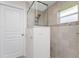Bathroom with walk-in shower featuring glass enclosure, pebble flooring, and modern fixtures at 15738 Applewhite Cir, Port Charlotte, FL 33981