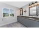 Well-lit bathroom featuring double sinks, granite countertops, modern fixtures, and a bright window at 15738 Applewhite Cir, Port Charlotte, FL 33981