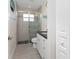 Bathroom with glass enclosed shower, modern fixtures, and beach-themed decorations at 15738 Applewhite Cir, Port Charlotte, FL 33981
