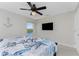 Bright bedroom with ceiling fan, a wall-mounted TV, and a ocean-themed bed at 15738 Applewhite Cir, Port Charlotte, FL 33981