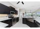 Stylish kitchen with stainless steel appliances, granite countertops, and modern fixtures at 15738 Applewhite Cir, Port Charlotte, FL 33981